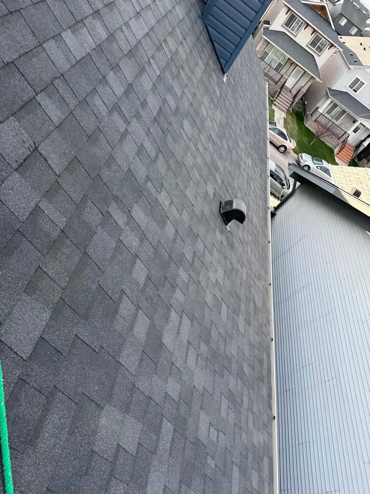 Four Brothers Exteriors roofer walking a freshly shingled Calgary roof